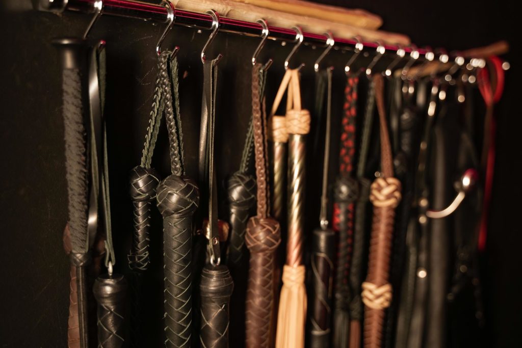 Whips for London Domination BDSM on a dark background. Accessory for sexual games.